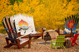 Firepit with custom hand built chairs made of skis at Creekside Chalets and Cabins Vacation Rentals in Salida, Colorado.