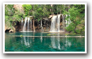 View of the famous Hanging Lake with floating log and turquoise water near Glenwood Springs, Colorado.