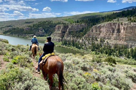 Guided horseback riders on trail in the Flat Tops Wilderness Area near Sweetwater Lake State Park, Colorado.